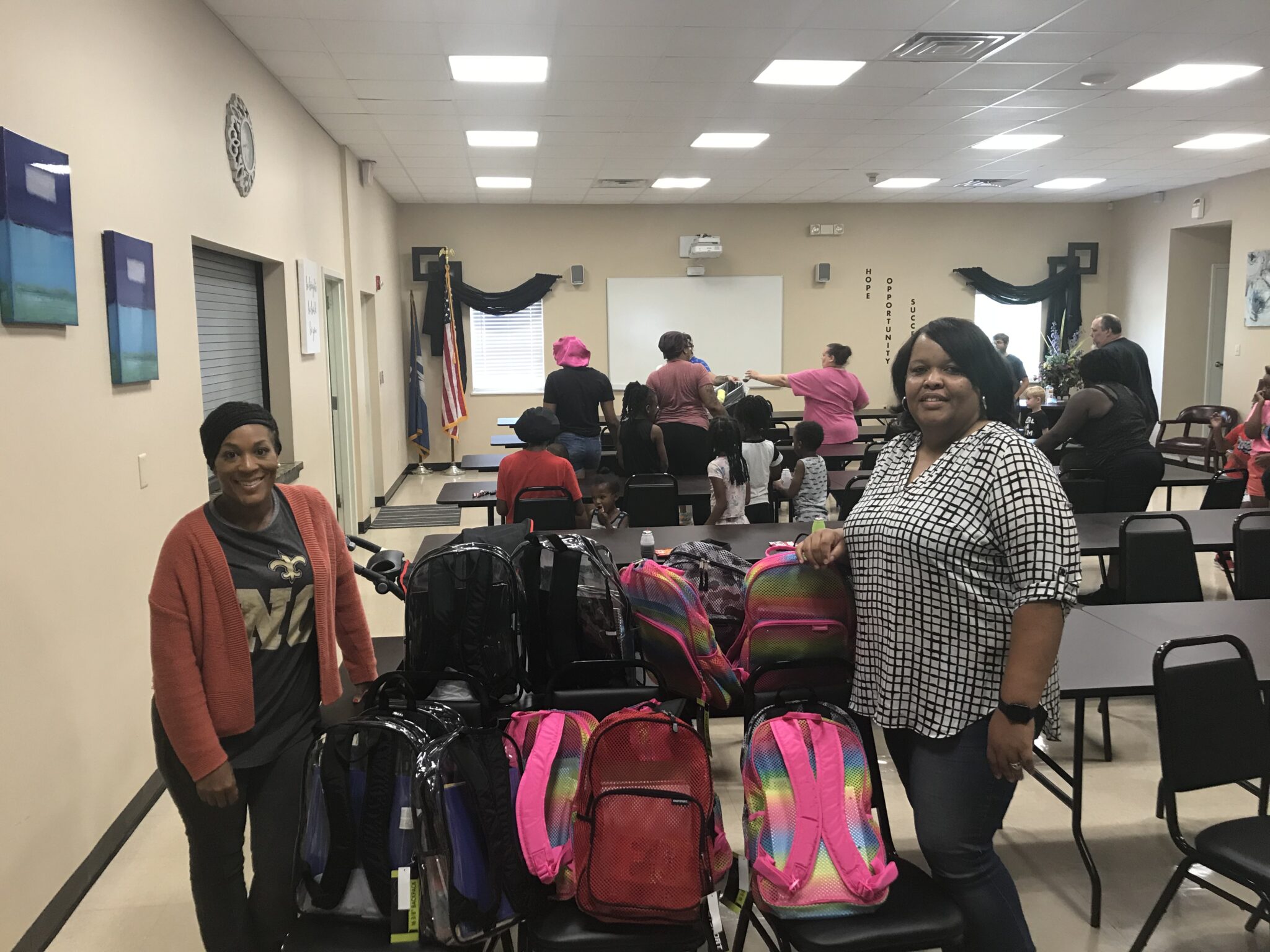 Ms. Shantale Miller And Ms. Karla West With Book Bags